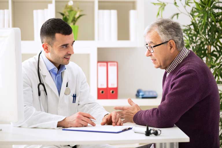 Doctor providing explanation of visit to patient.